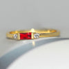 Gold Ring with a Radiant Red Centre Stone